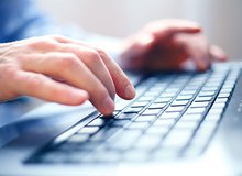 hands writing on keyboard